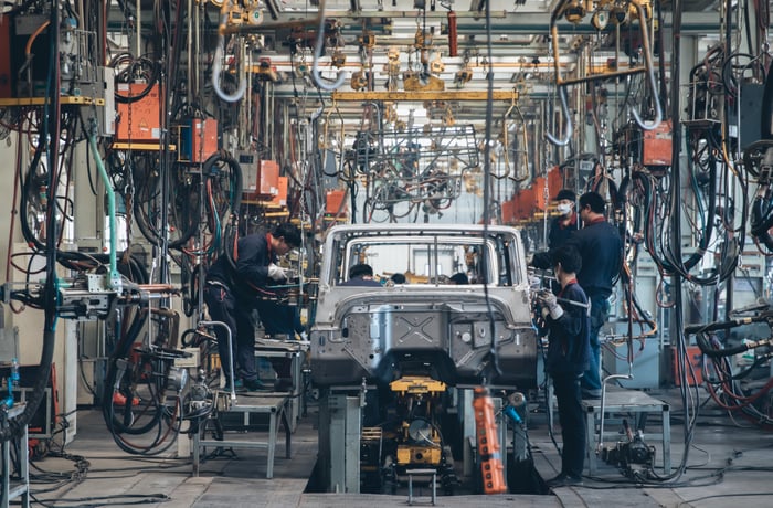 People working on a car assembly line