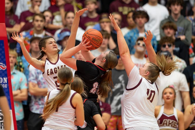 Silver Lake's Ella Bolan (22) and Makenzie McDaniel (10) defend against Hesston's Kaycee Mason (20) during State Basketball Championships March. 9, 2024 at Hutchinson Sports Arena.