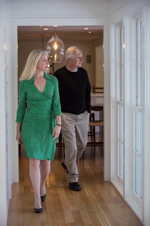 Agents Nancy Warren Farley and Jay Strausser of Four Seasons Sotheby's International Realty tour a home for sale.