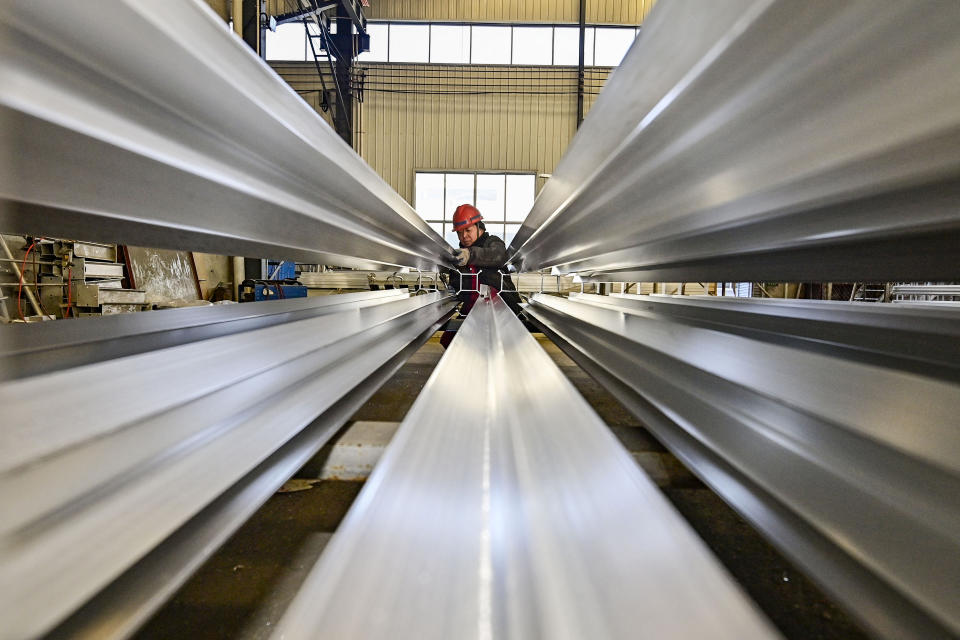 An employee works on a steel pipe produced from iron ore at a factory in Weifang, in China's eastern Shandong province