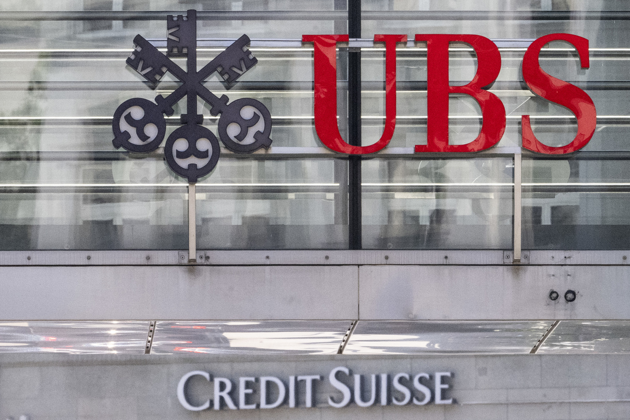 Red UBS logo above the white credit suisse logo.