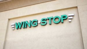 The logo for Wingstop is displayed on a building wall.