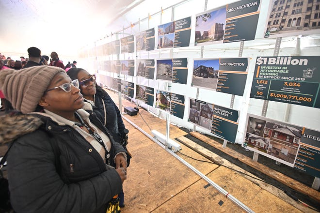 City of Detroit Labor Standard Specialists Jennifer Thomas and Jacqueline Jackson look over pictures or all 71 affordable housing projects built, or are under construction, in the last 5 years, during a celebrations for the $1 billions dollars reached in affordable housing during a press conference in Detroit, Michigan on April 12, 2024.