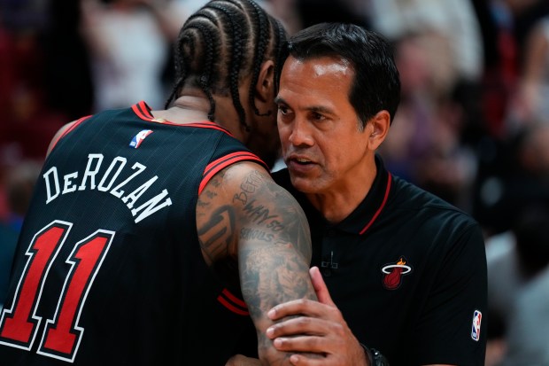 Heat coach Erik Spoelstra speaks to Bulls forward DeMar DeRozan after a play-in tournament game on April 19, 2024, in Miami. (Rich Storry/Getty Images)